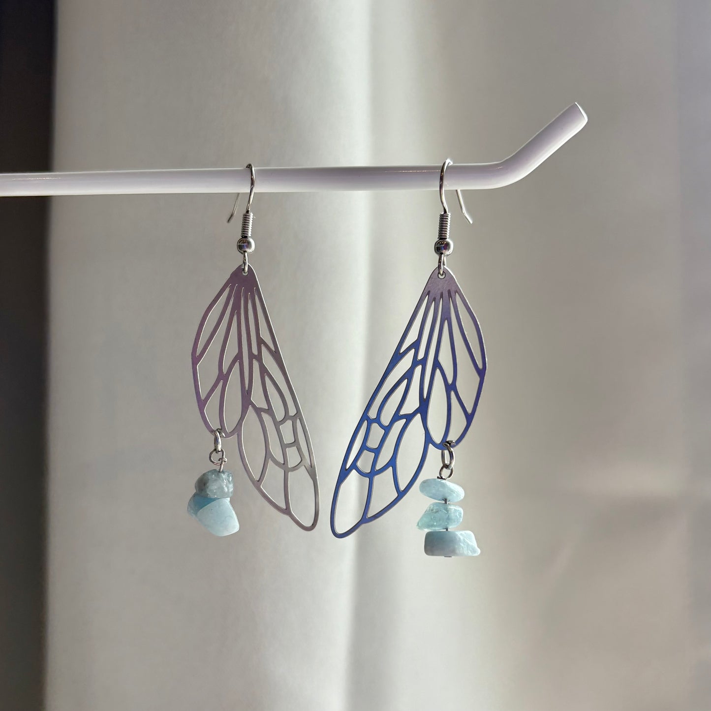 Stainless steel silver fairy wing dangle earrings with blue aquamarine crystals