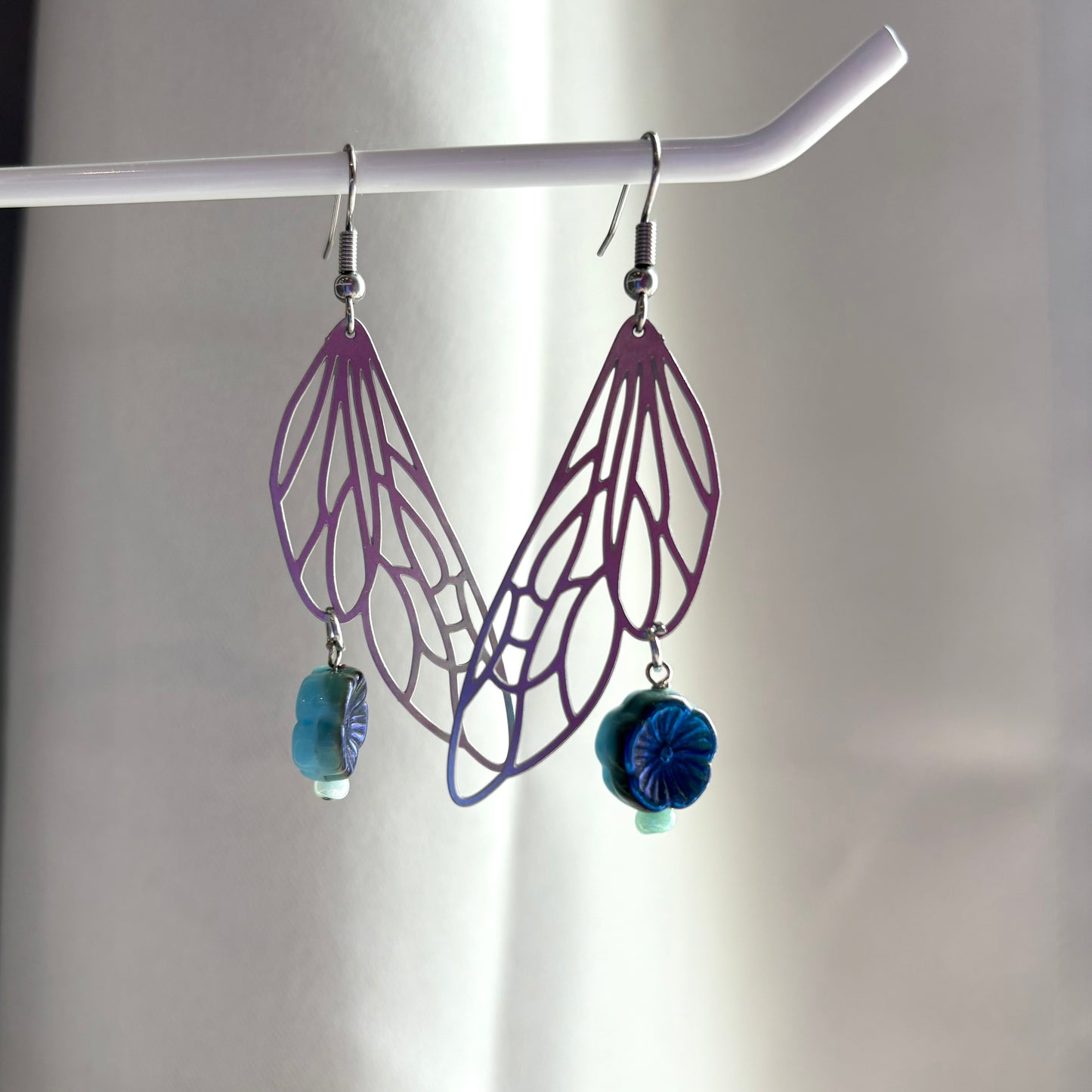 Stainless steel silver fairy wing dangle earrings with blue reversible blue flowers