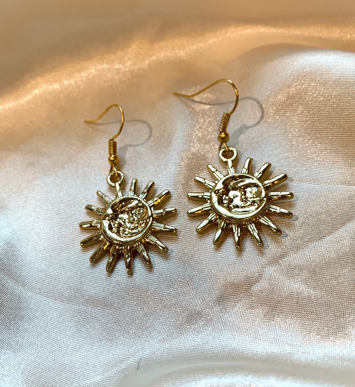 Cool quirky gold sun and moon face celestial dangle earrings