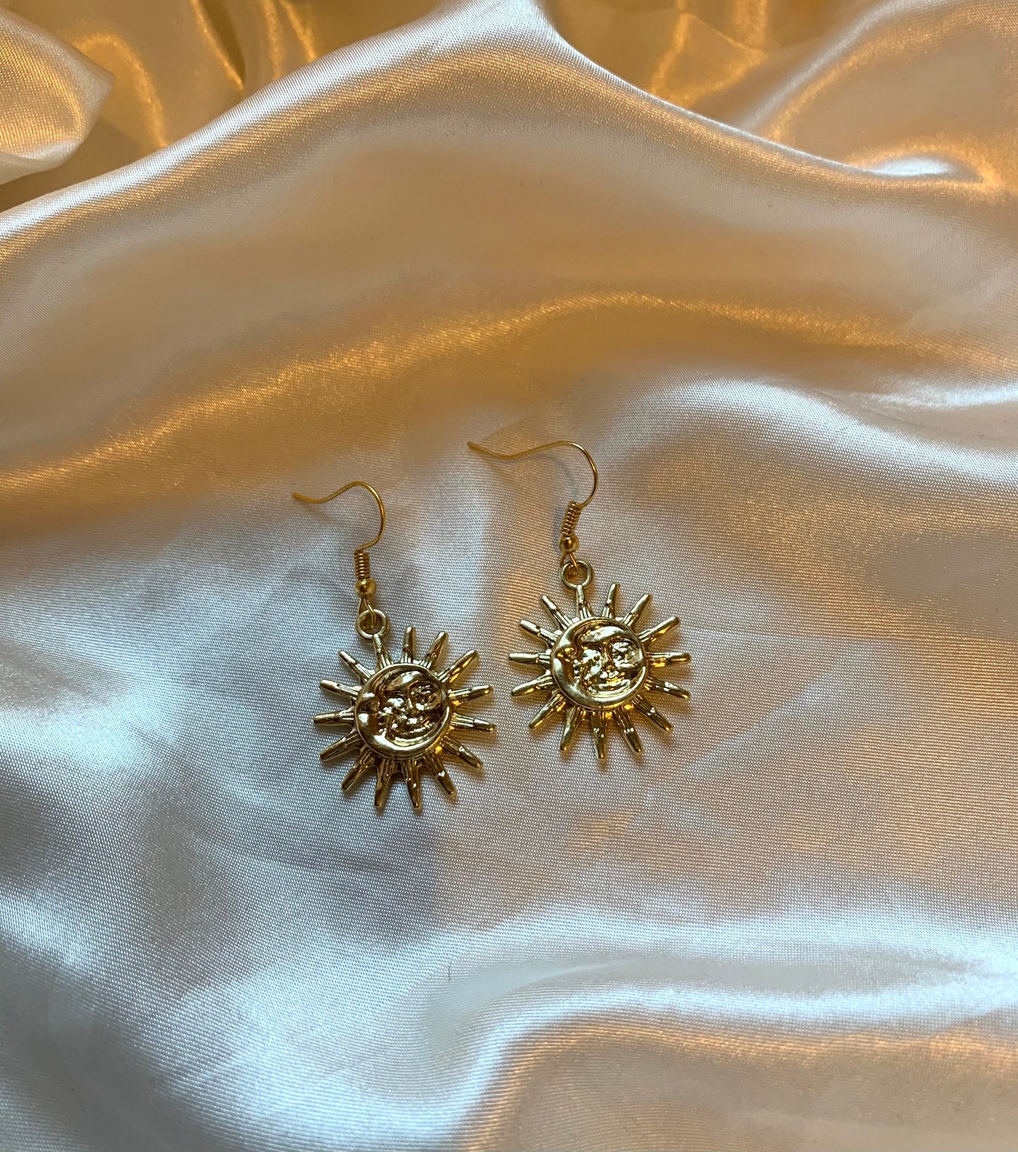 Cool quirky gold sun and moon face celestial dangle earrings
