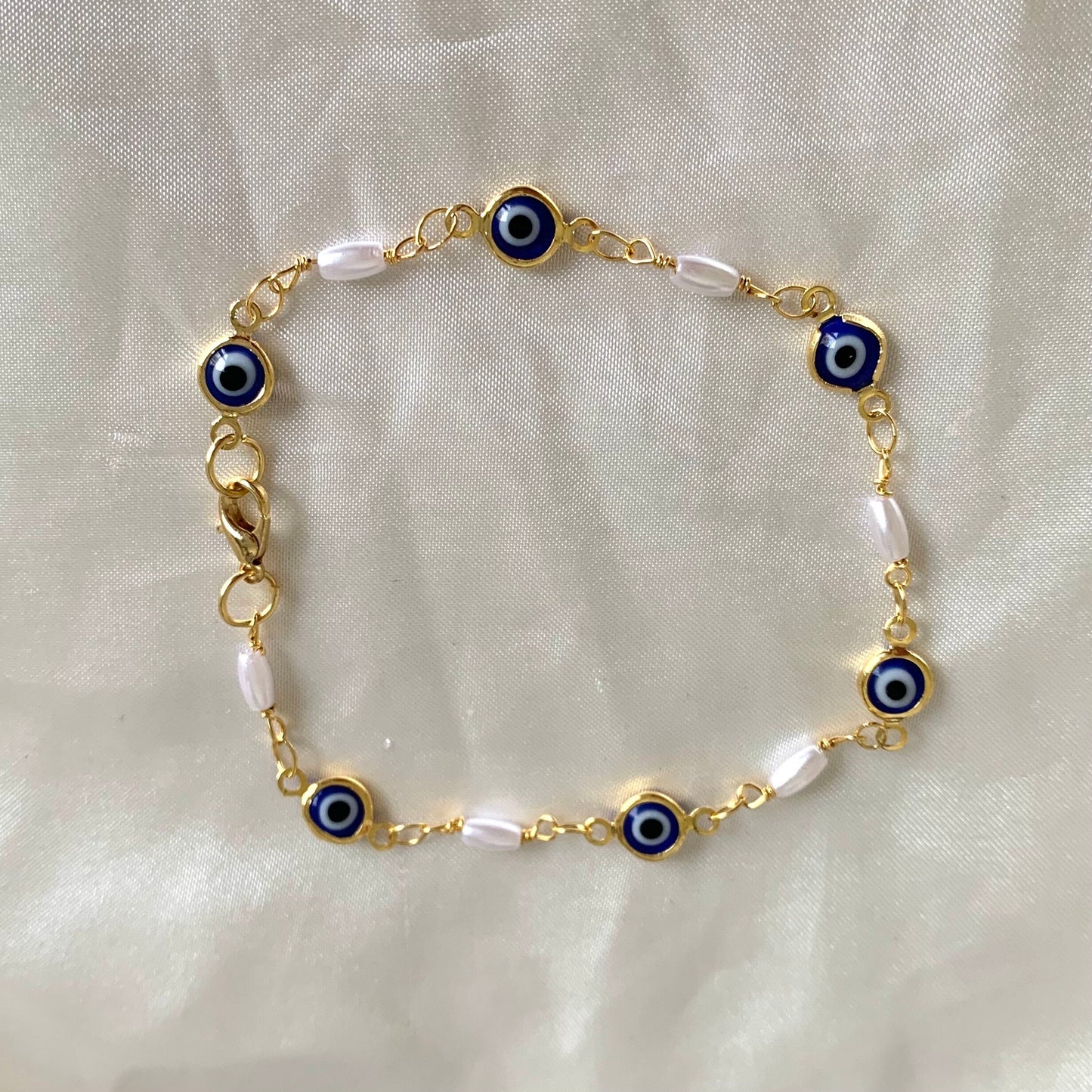 Gold plated blue evil eye and faux pearl bracelet