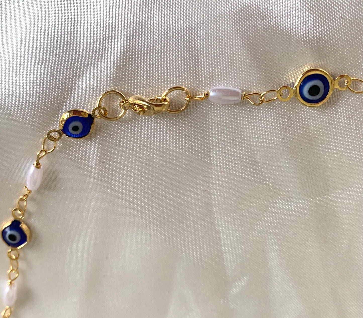 Gold plated blue evil eye and faux pearl bracelet