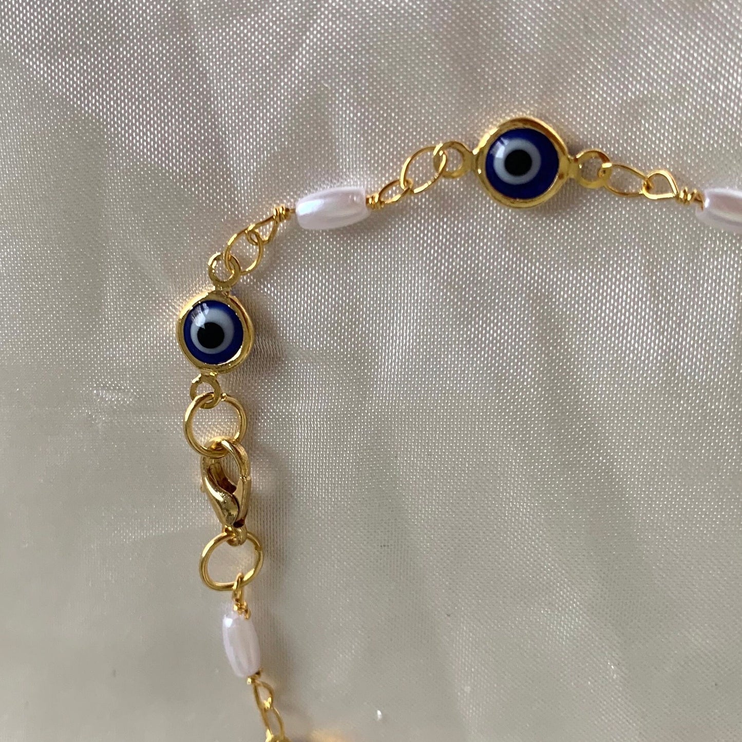 Gold plated blue evil eye and faux pearl bracelet