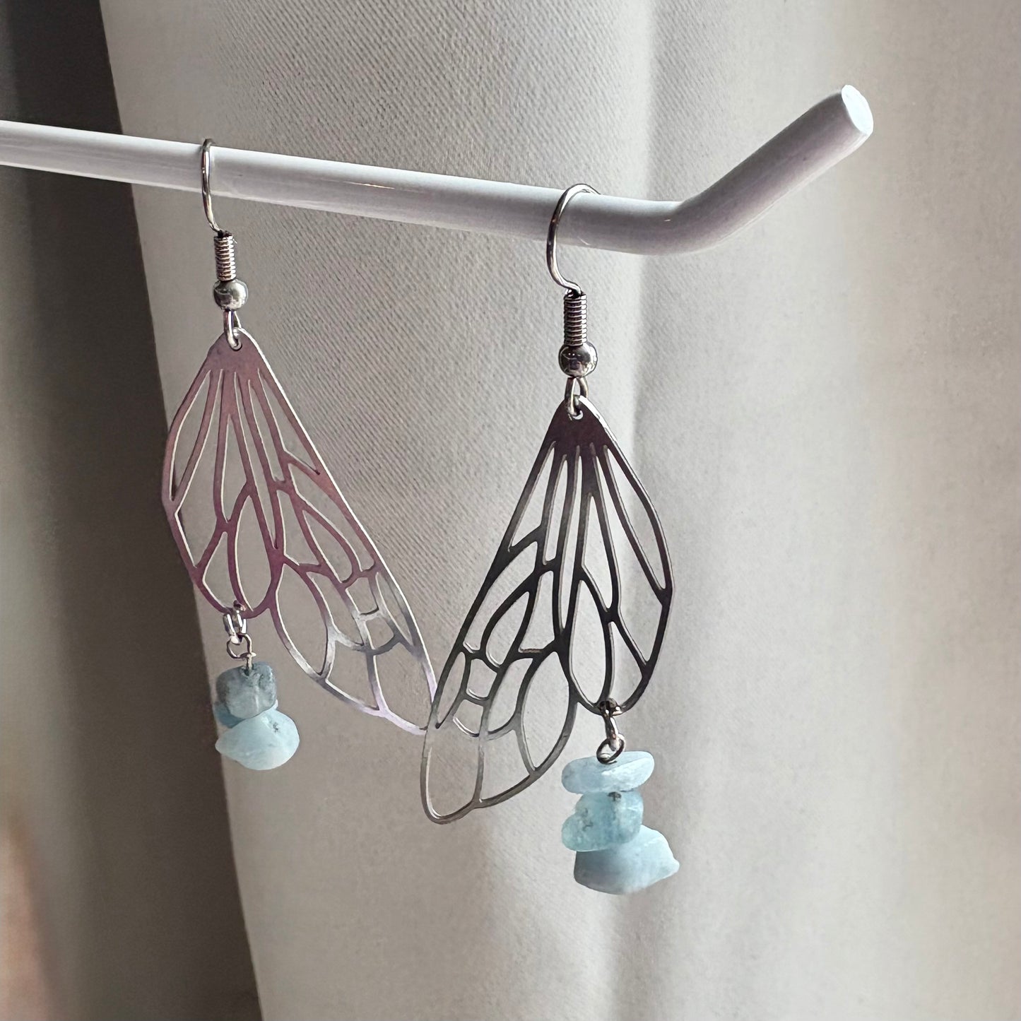 Stainless steel silver fairy wing dangle earrings with blue aquamarine crystals