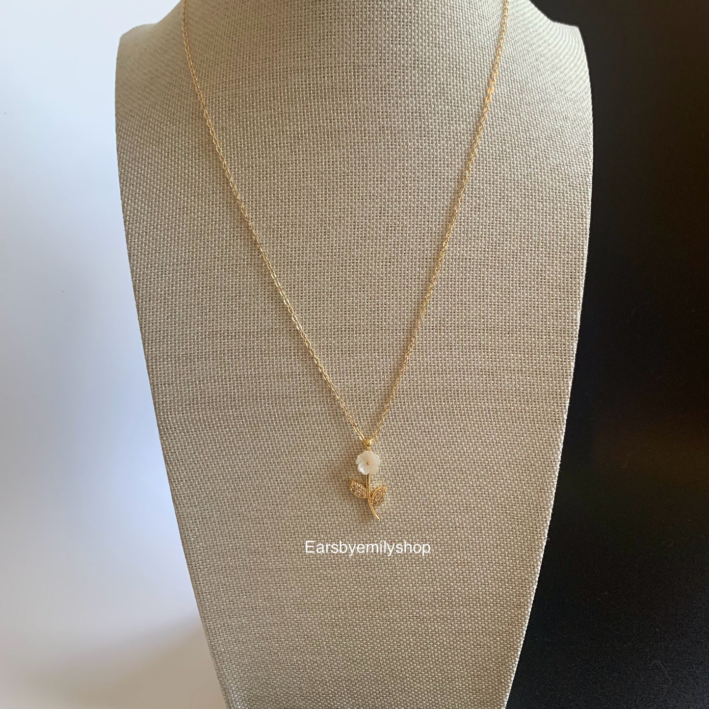 Gold plated white flower pendant with white crystal diamanté necklace