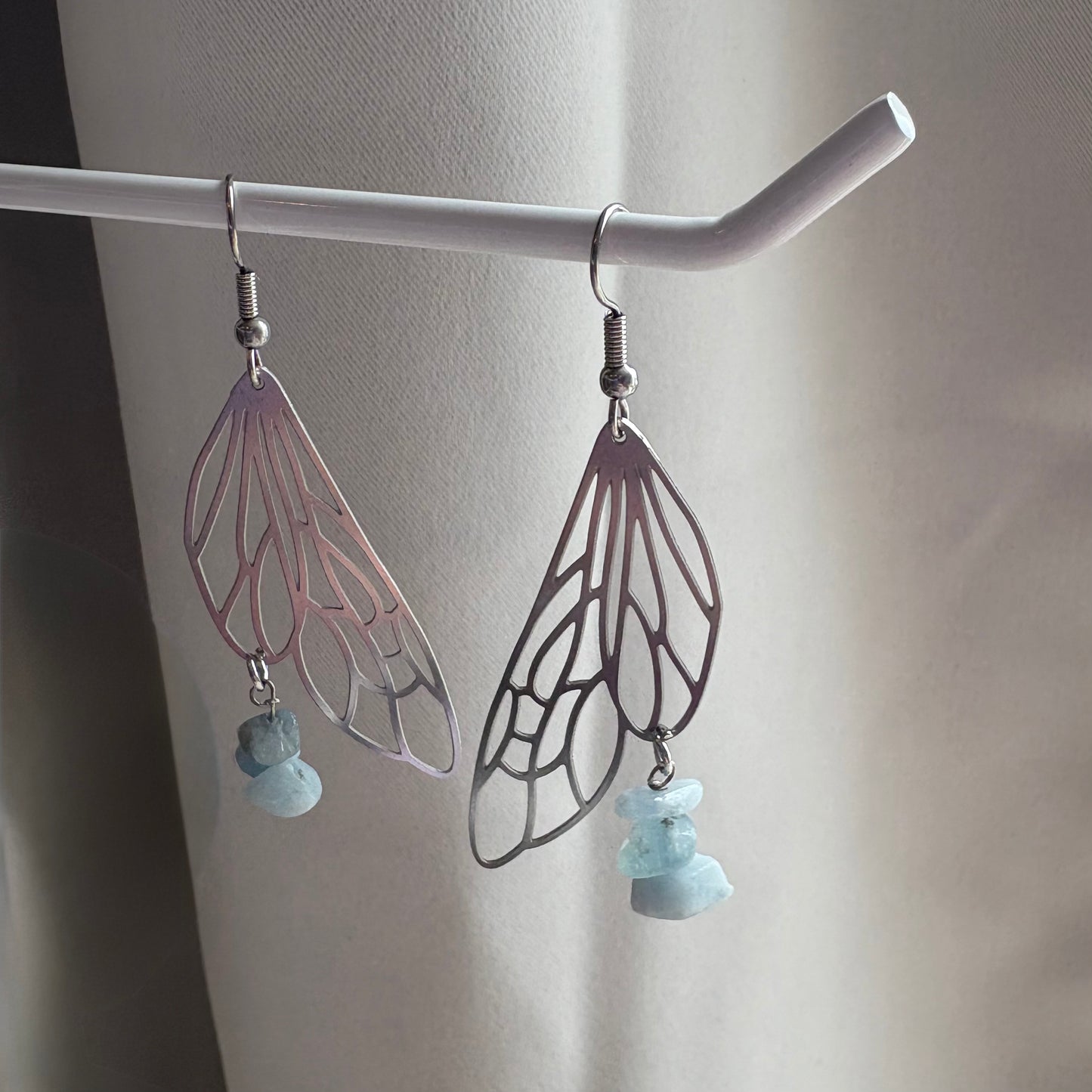 Stainless steel silver fairy wing dangle earrings with blue aquamarine crystals