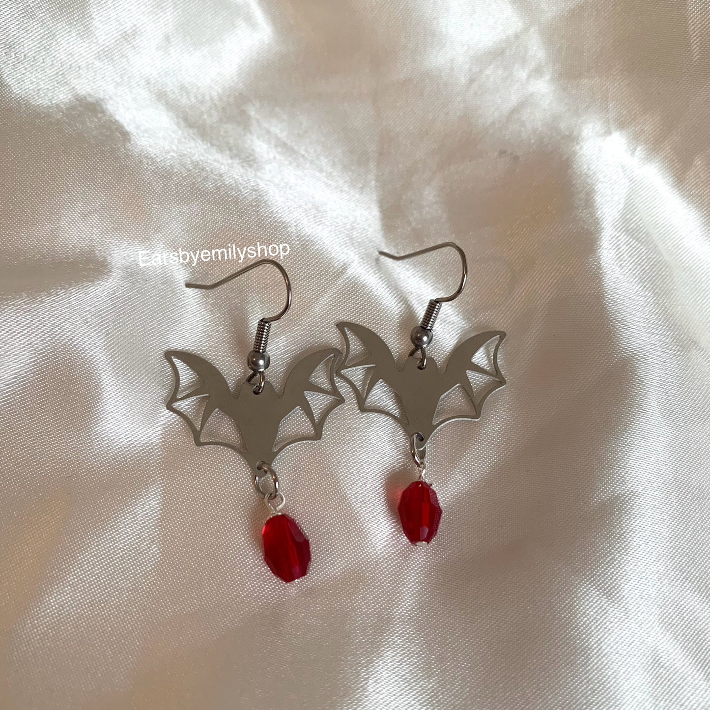 Silver stainless steel bats with red oval charm dangle earrings