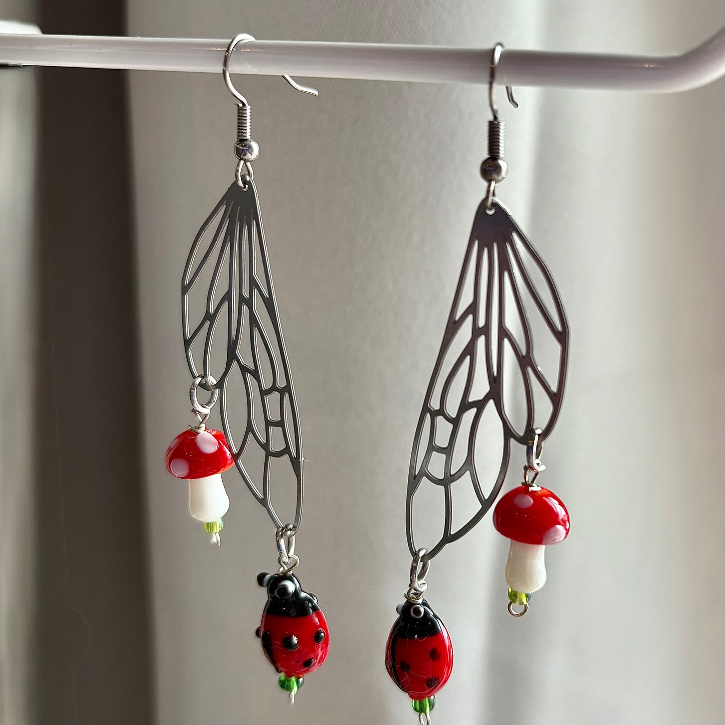 Stainless steel silver fairy wing earrings with mushrooms and ladybirds