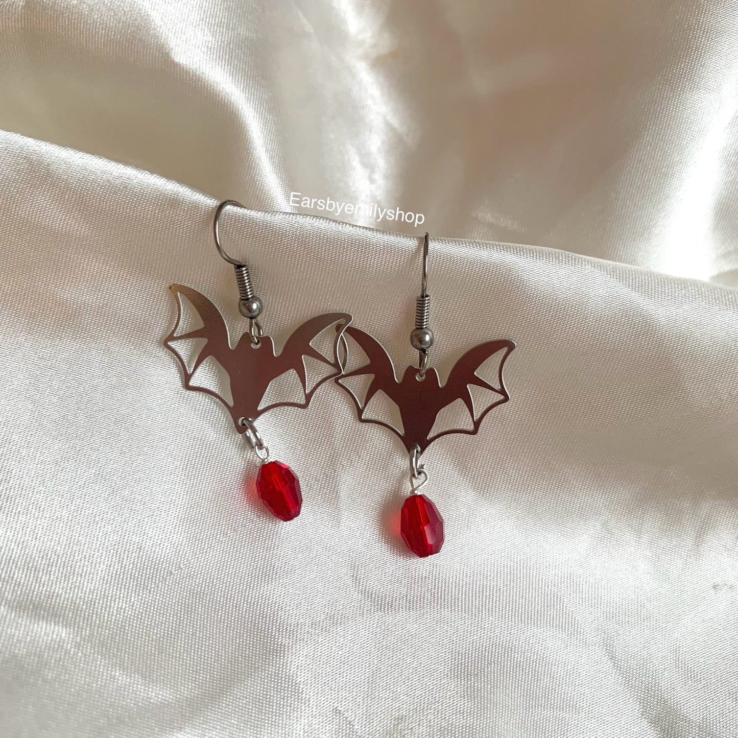 Silver stainless steel bats with red oval charm dangle earrings