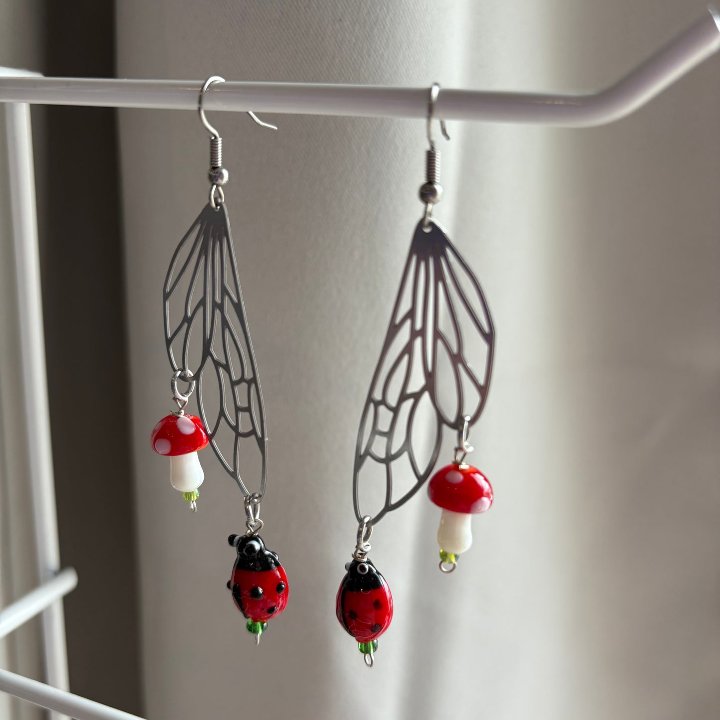 Stainless steel silver fairy wing earrings with mushrooms and ladybirds