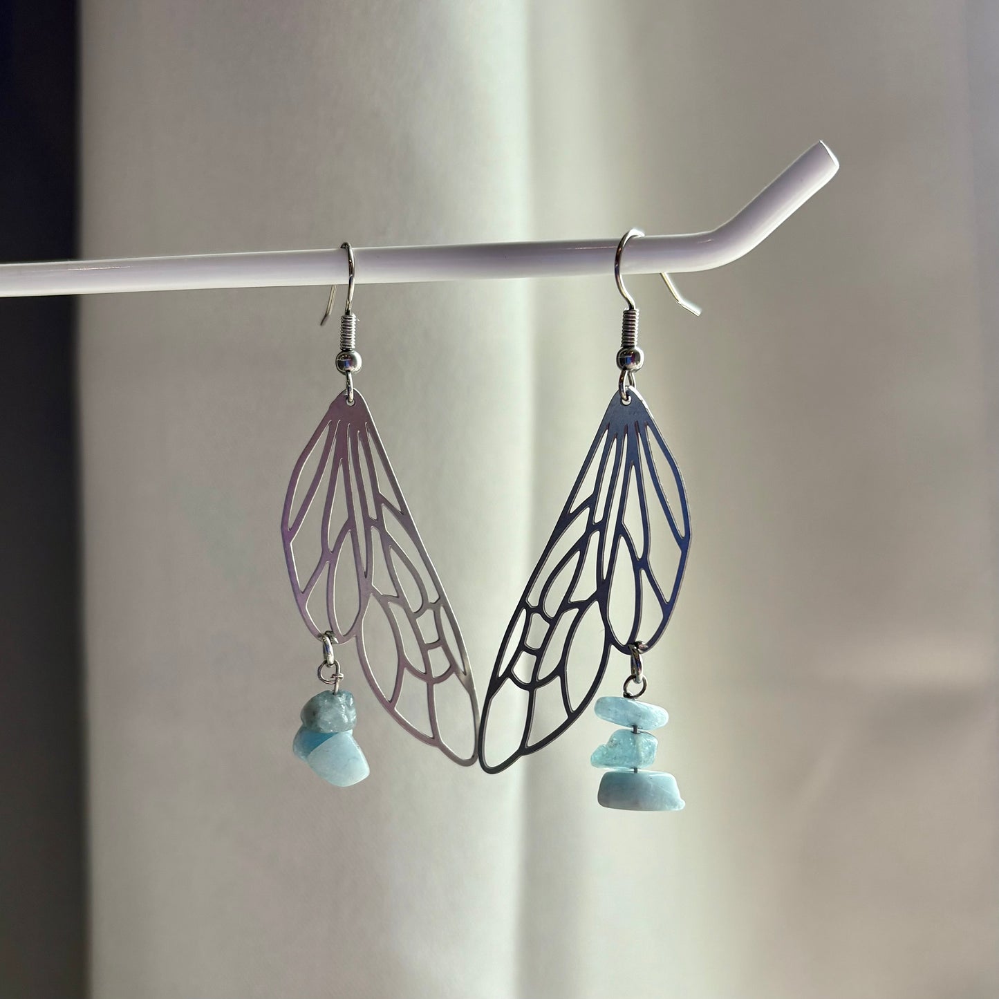 Stainless steel silver fairy wing dangle earrings with blue aquamarine crystals