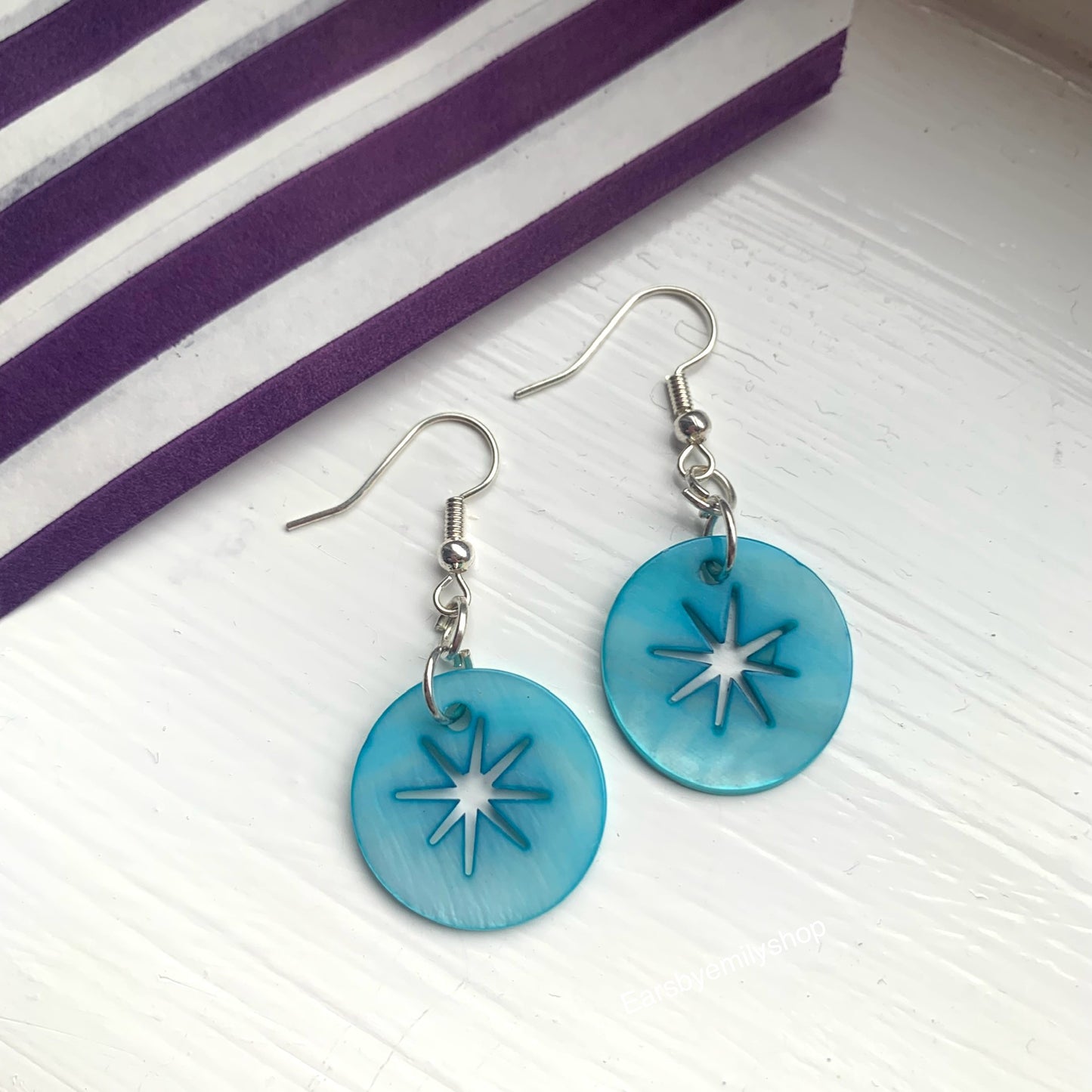 Cool quirky  beach inspired blue sea shell disc earrings with star cut out on silver plated hooks