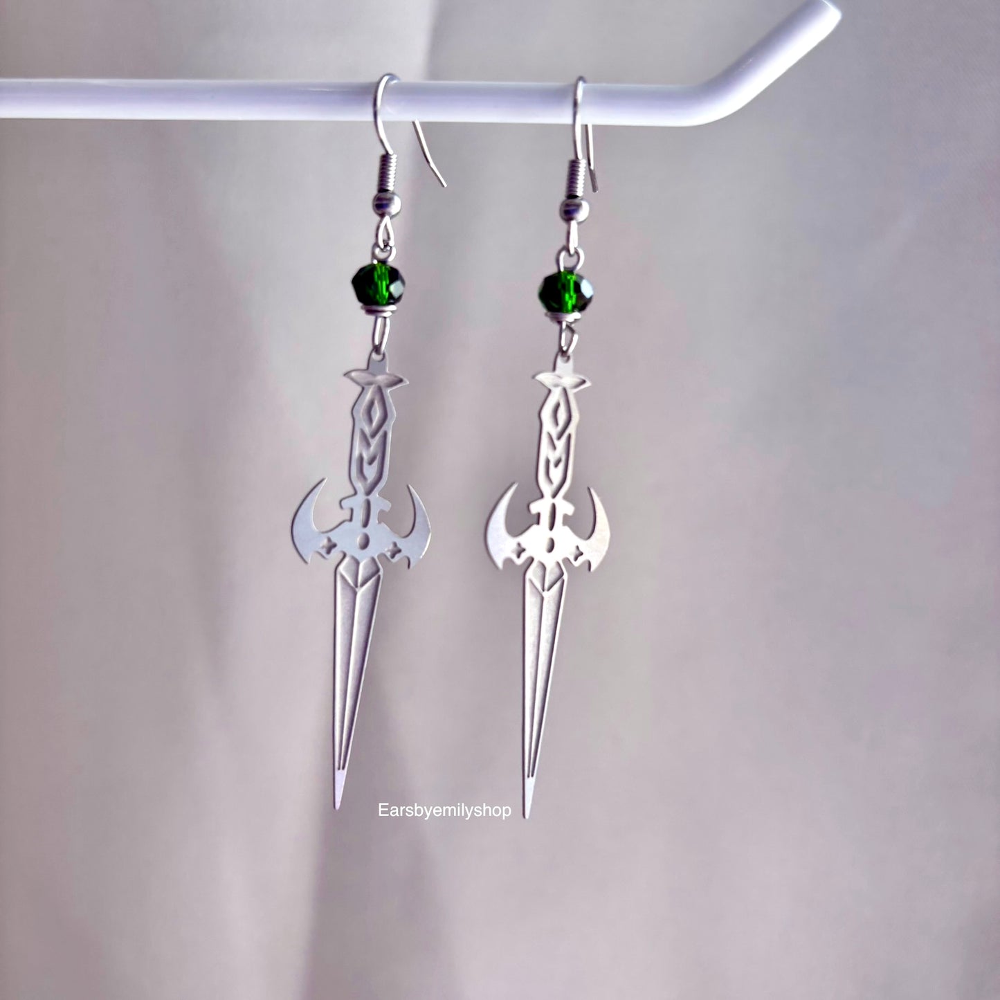 Stainless steel silver cool sword earrings with red or green bead