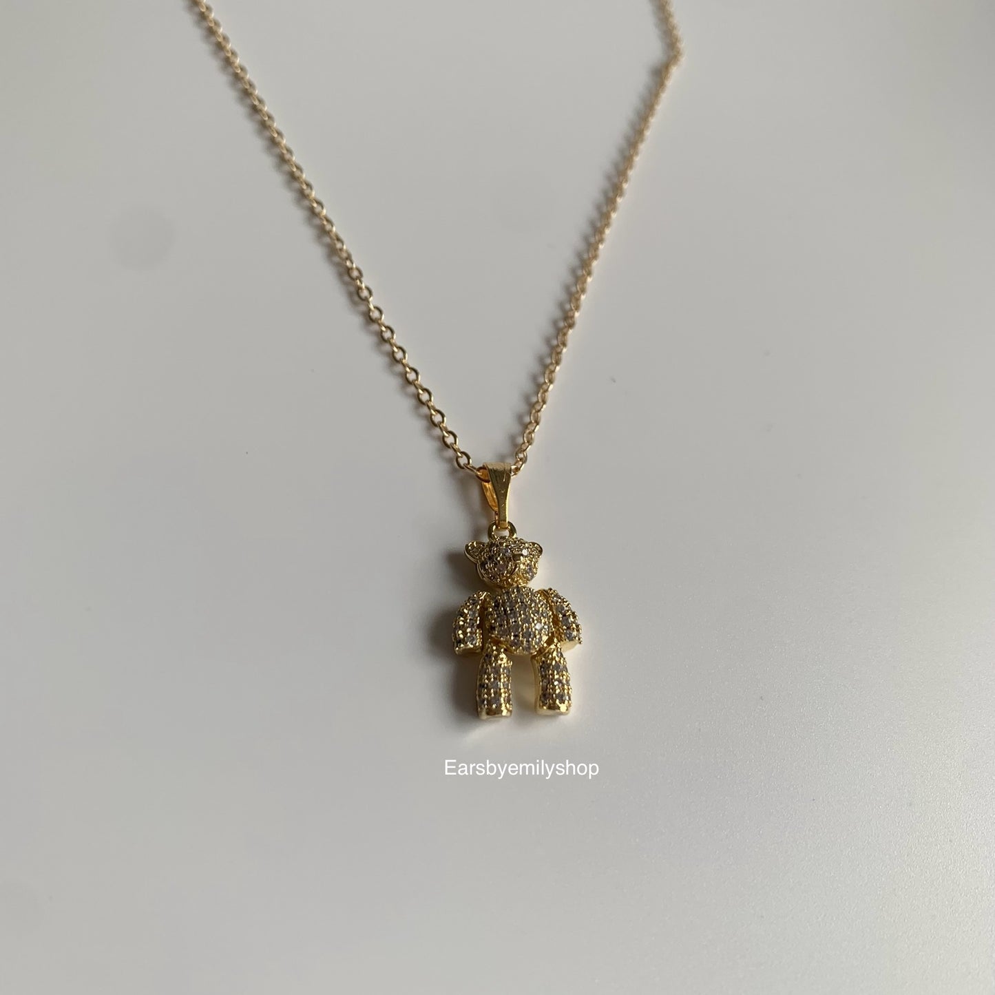 Gold plated moveable teddy bear with white crystal diamanté necklace