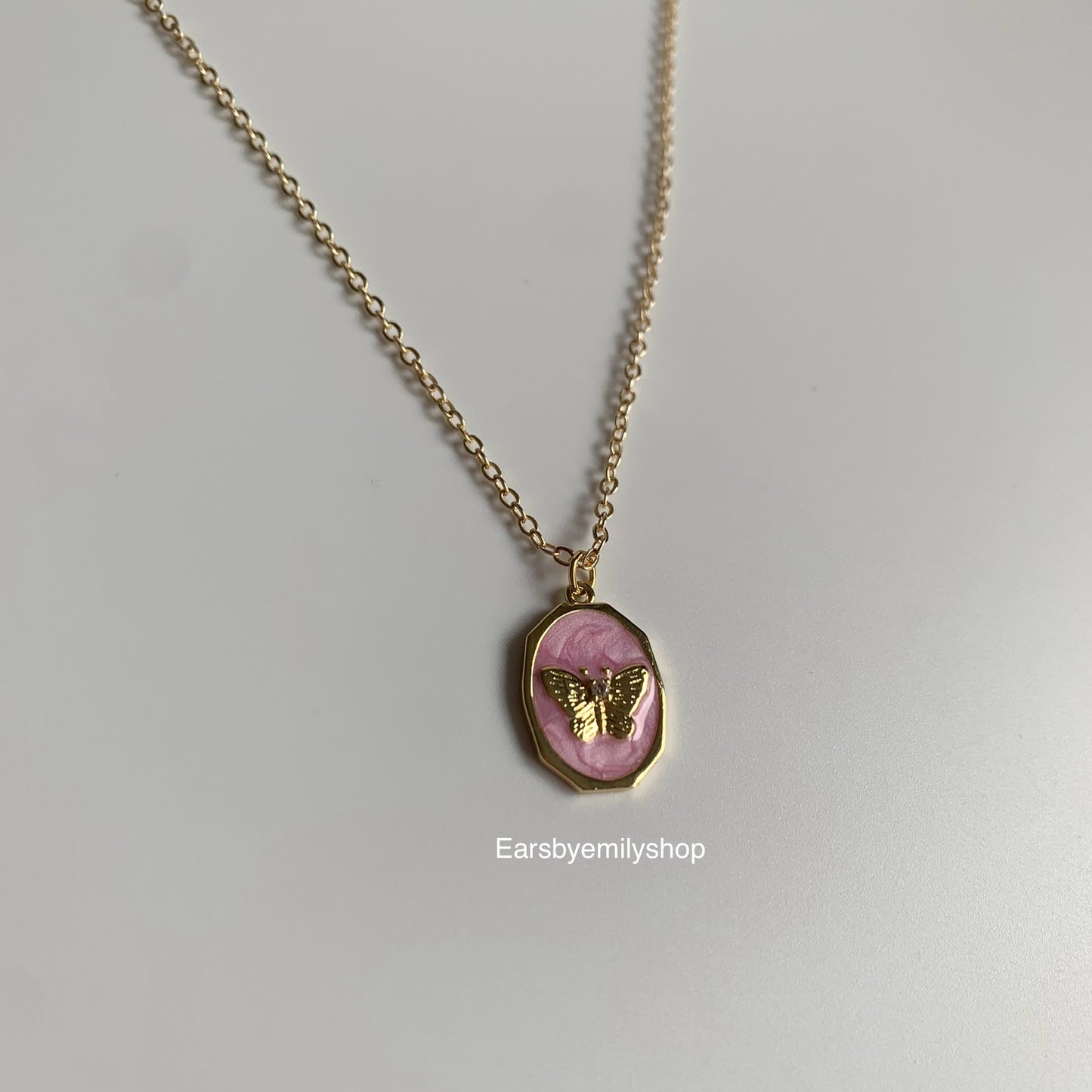 Gold plated oval pink enamel mother with butterfly pendant necklace