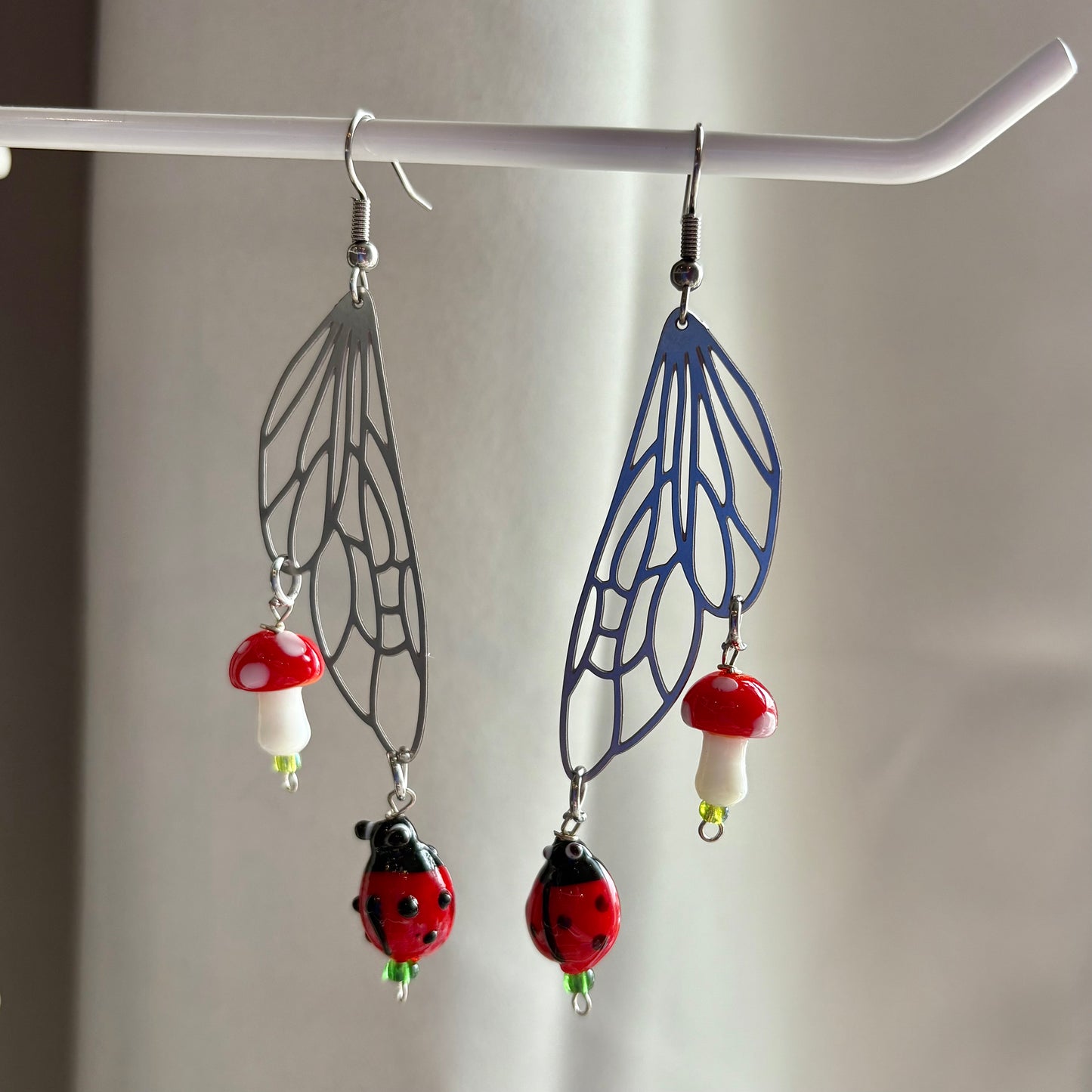 Stainless steel silver fairy wing earrings with mushrooms and ladybirds