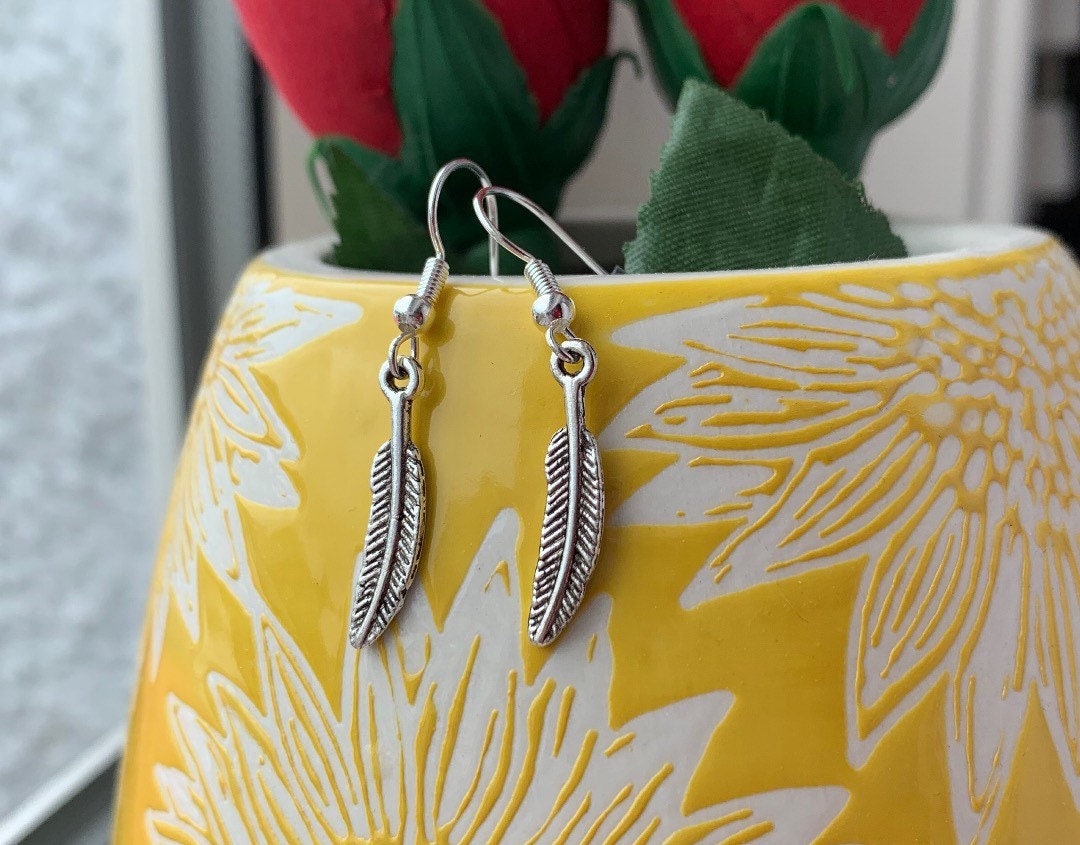 Silver bird feather dangle earrings