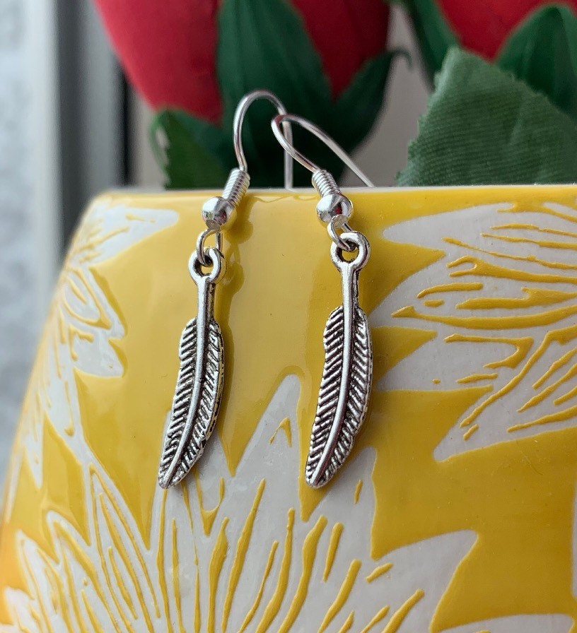 Silver bird feather dangle earrings