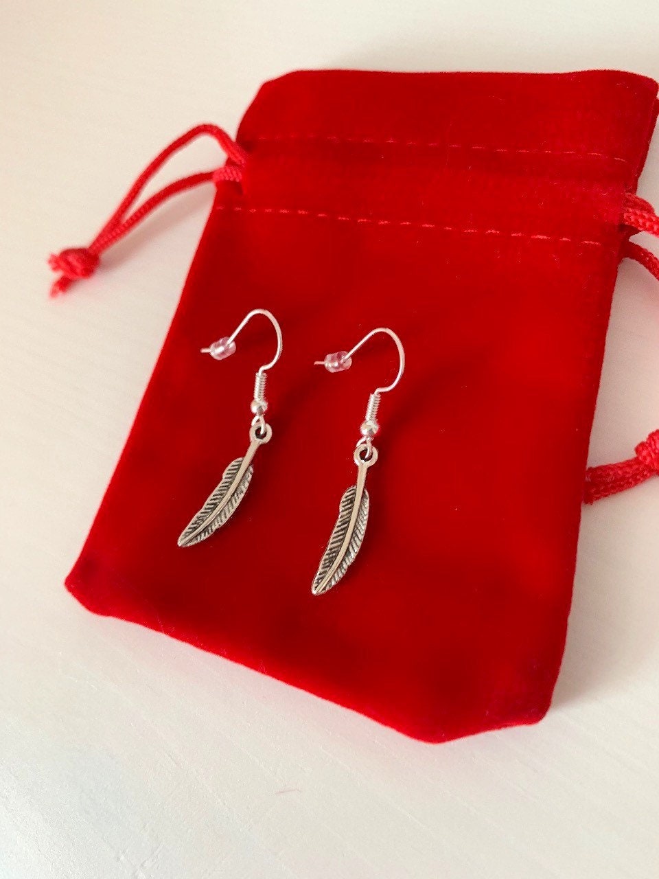 Silver bird feather dangle earrings