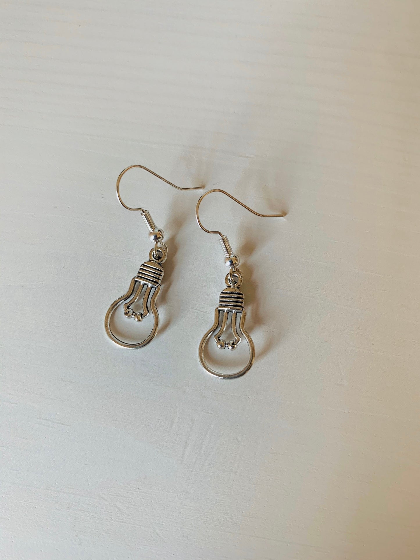 Silver light bulb dangle earrings