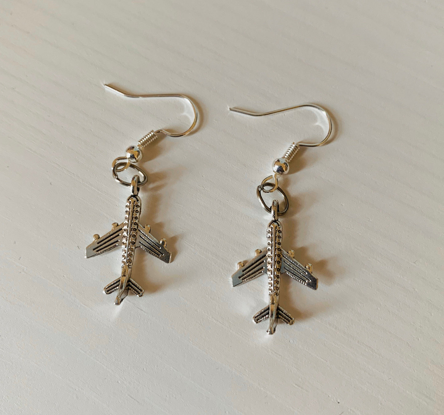 Silver plane flight dangle earrings