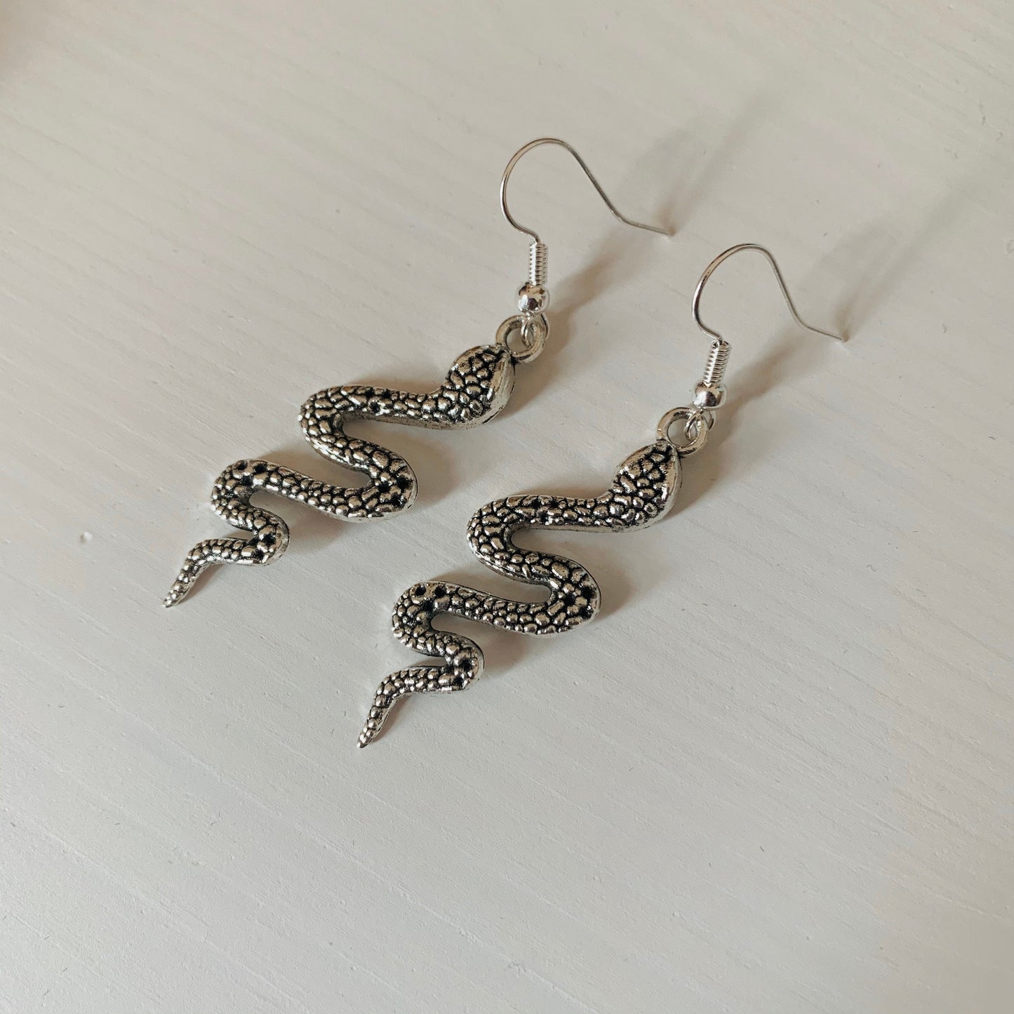 Silver snake dangle earrings