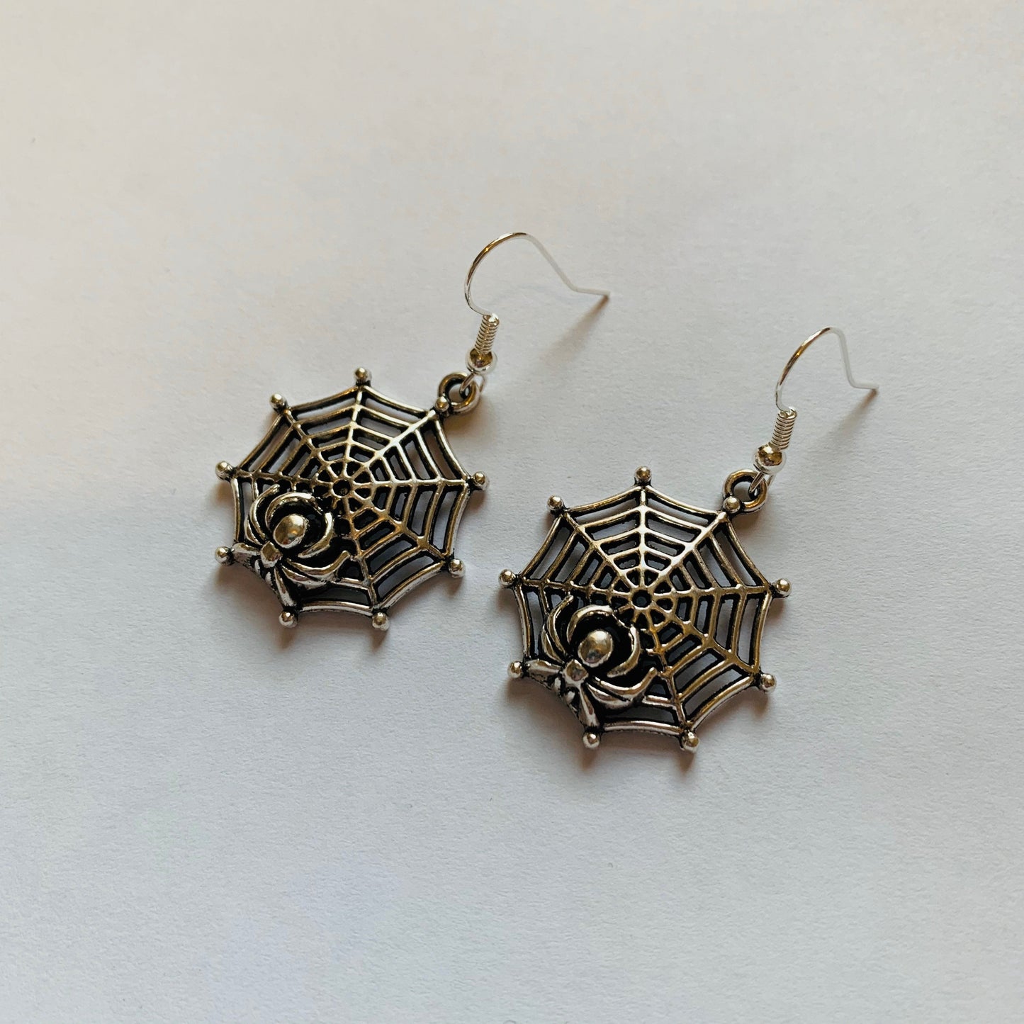 Silver spider web halloween earrings