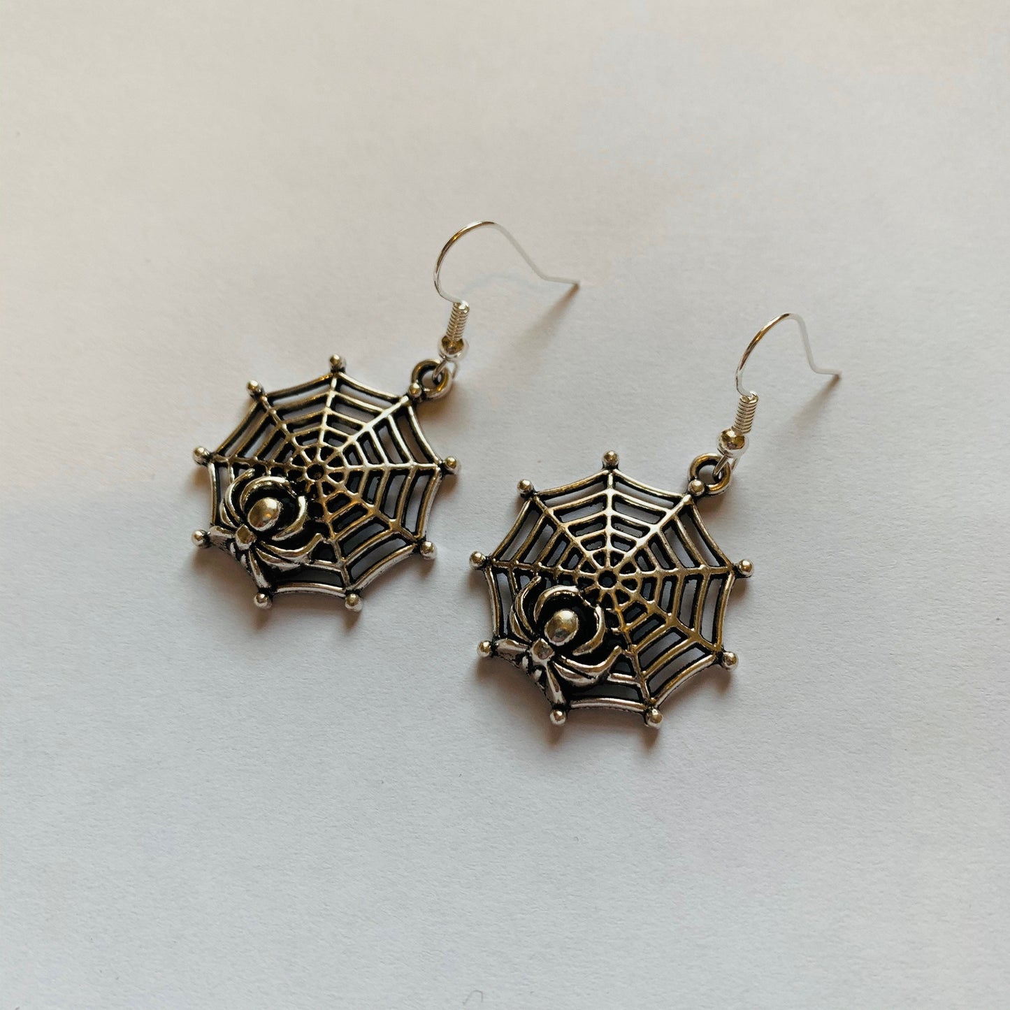 Silver spider web halloween earrings