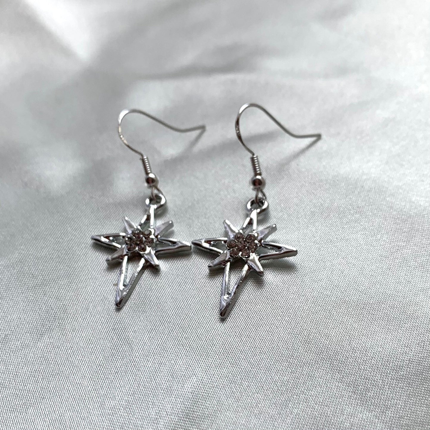 Silver north start diamante dangle earrings