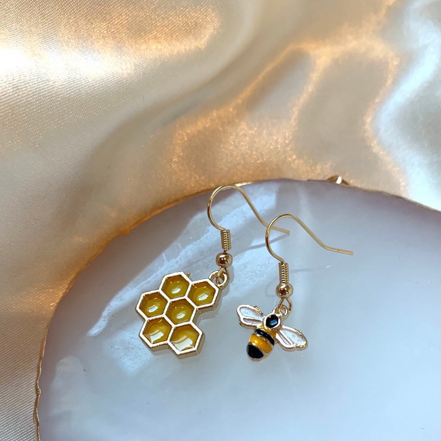 Yellow and black gold bee earrings with yellow honey comb