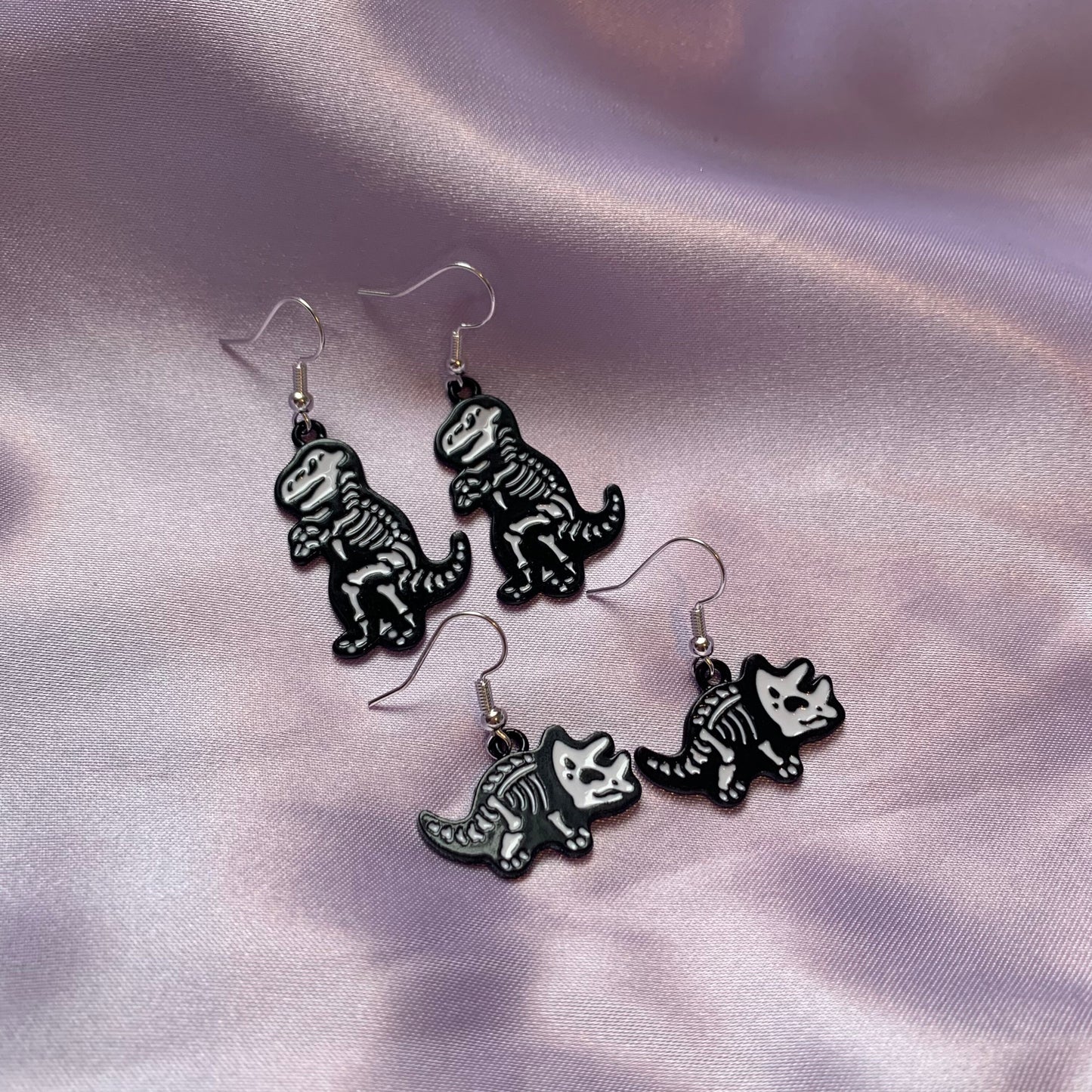 Dinosaur t-rex and triceratops black and white cartoon skeleton earrings