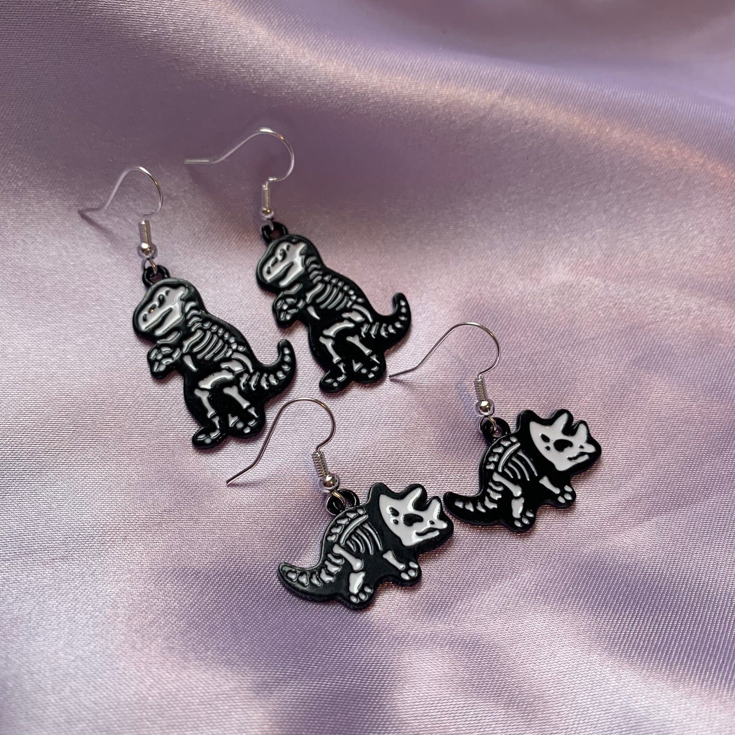 Dinosaur t-rex and triceratops black and white cartoon skeleton earrings