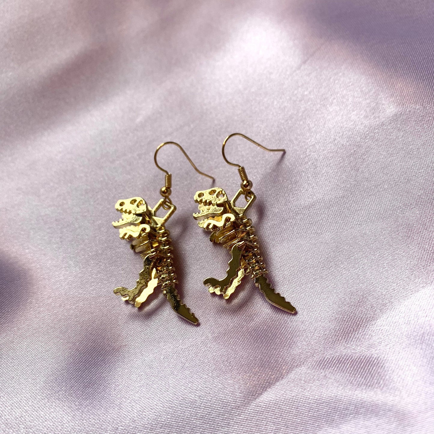 Gold dinosaur t-Rex skeleton earrings