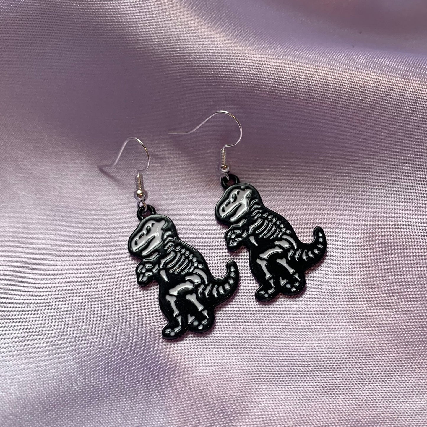 Dinosaur t-rex and triceratops black and white cartoon skeleton earrings