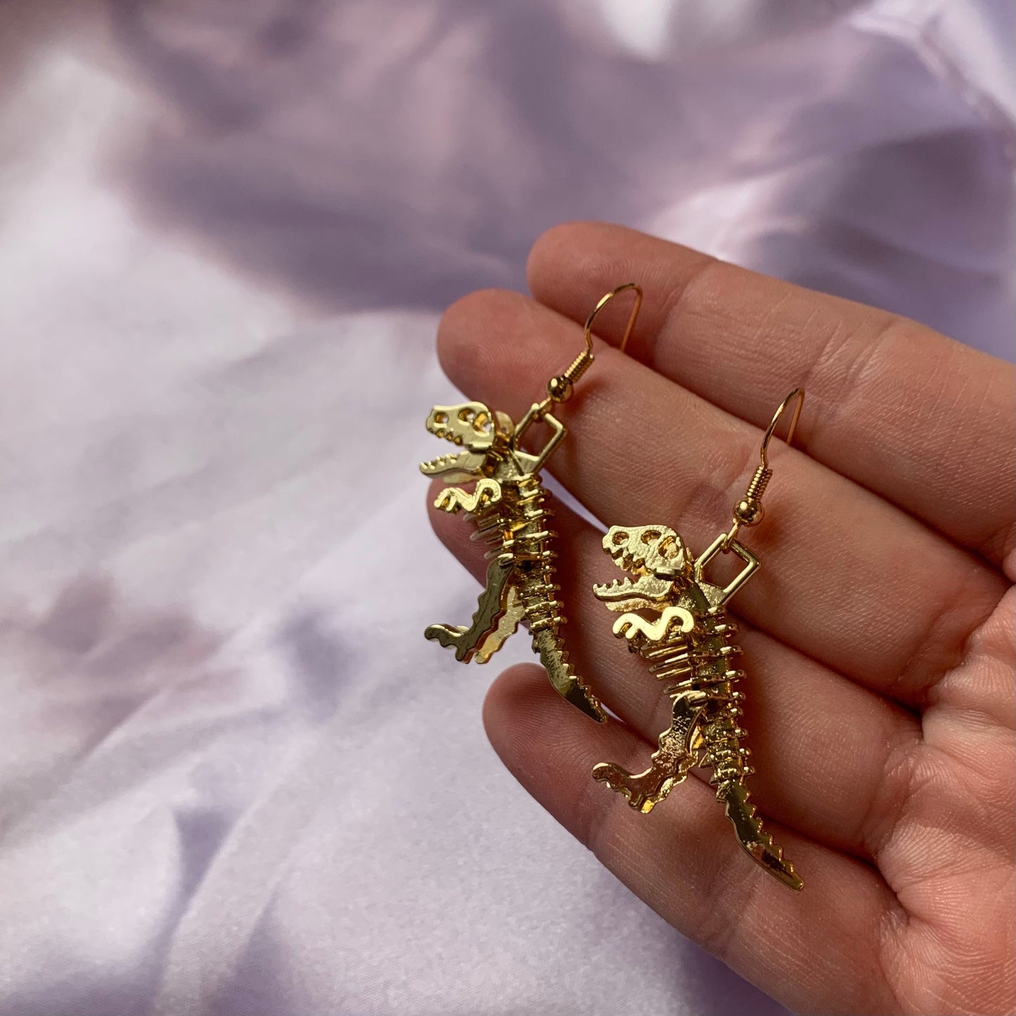 Gold dinosaur t-Rex skeleton earrings