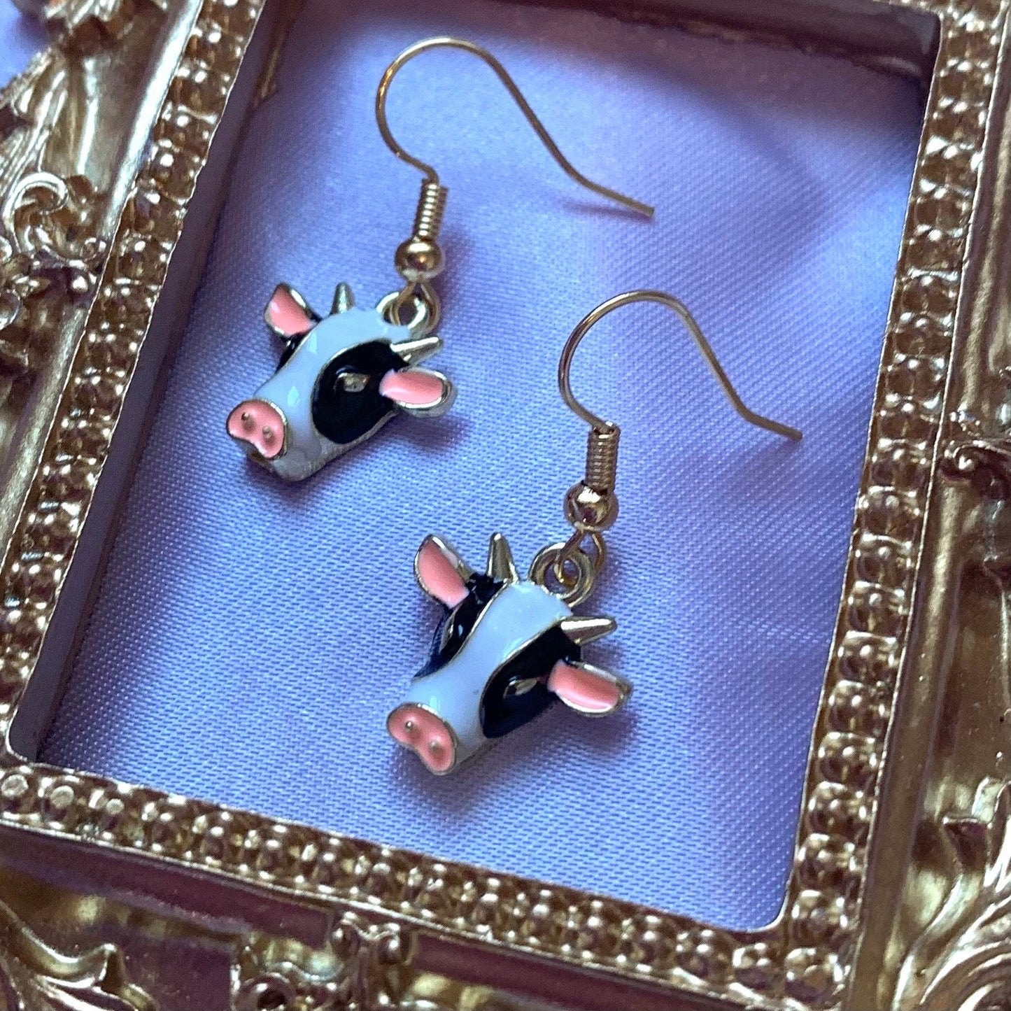 Black and white enamel cow gold earrings