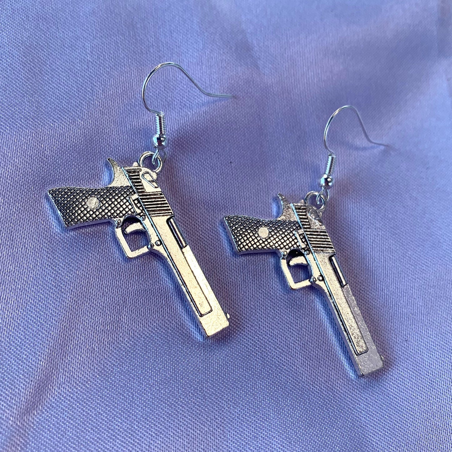 Silver gun dangle earrings