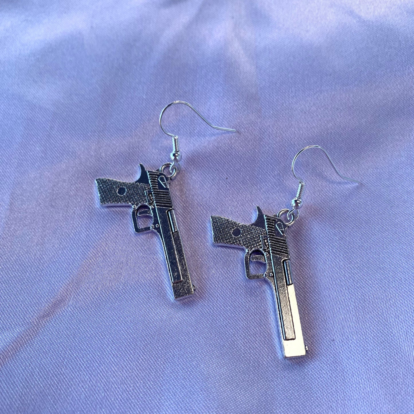 Silver gun dangle earrings