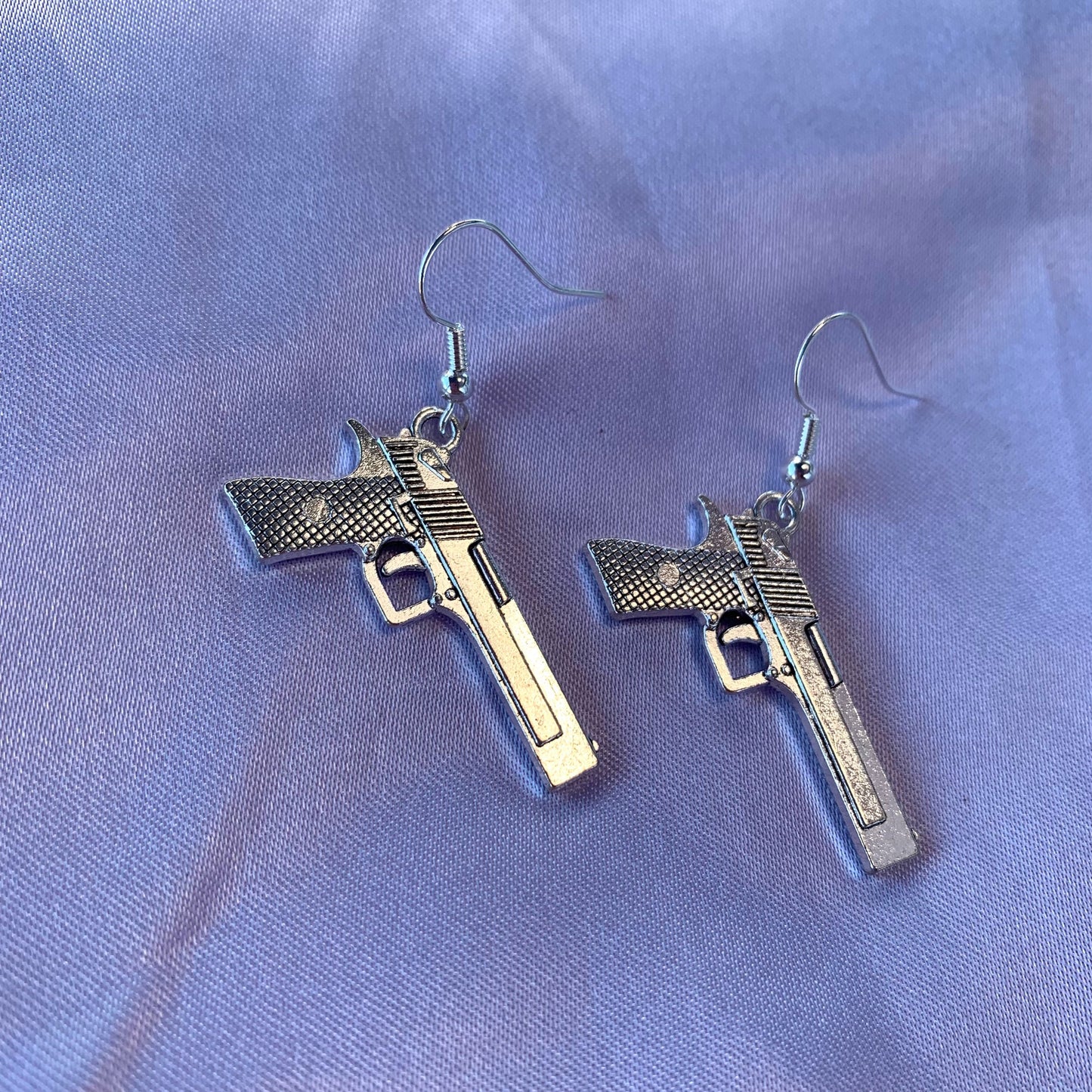 Silver gun dangle earrings