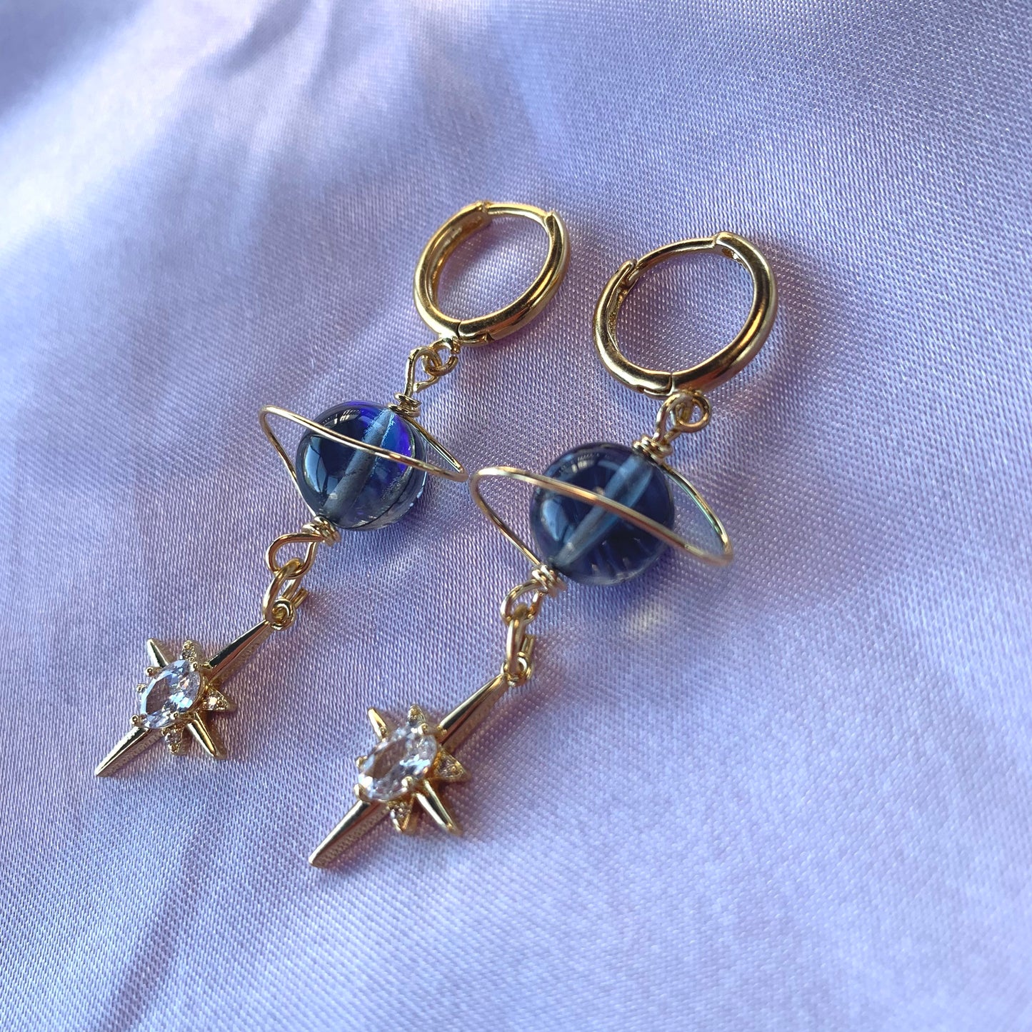 Gold plated celestial Saturn planet dangle hoop earrings with diamanté star