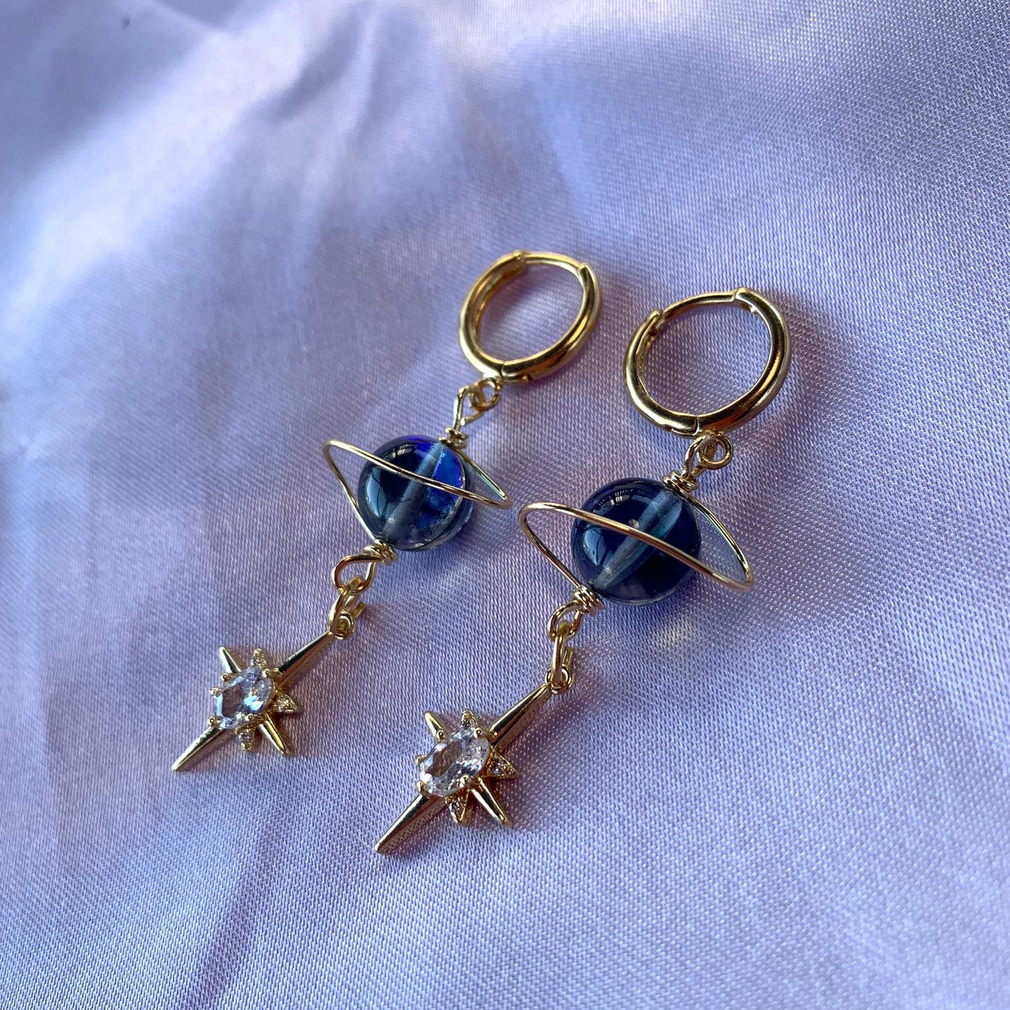 Gold plated celestial Saturn planet dangle hoop earrings with diamanté star