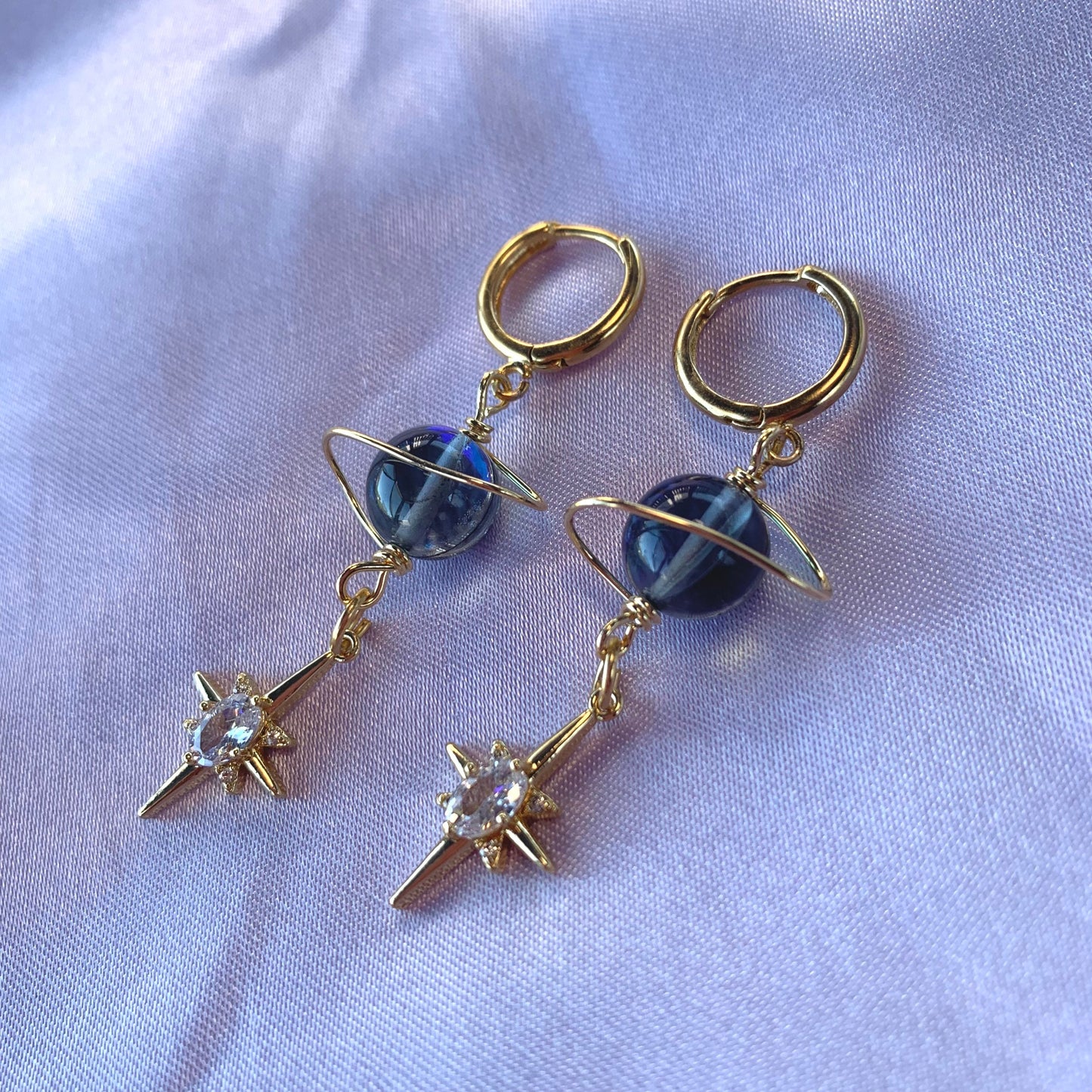 Gold plated celestial Saturn planet dangle hoop earrings with diamanté star