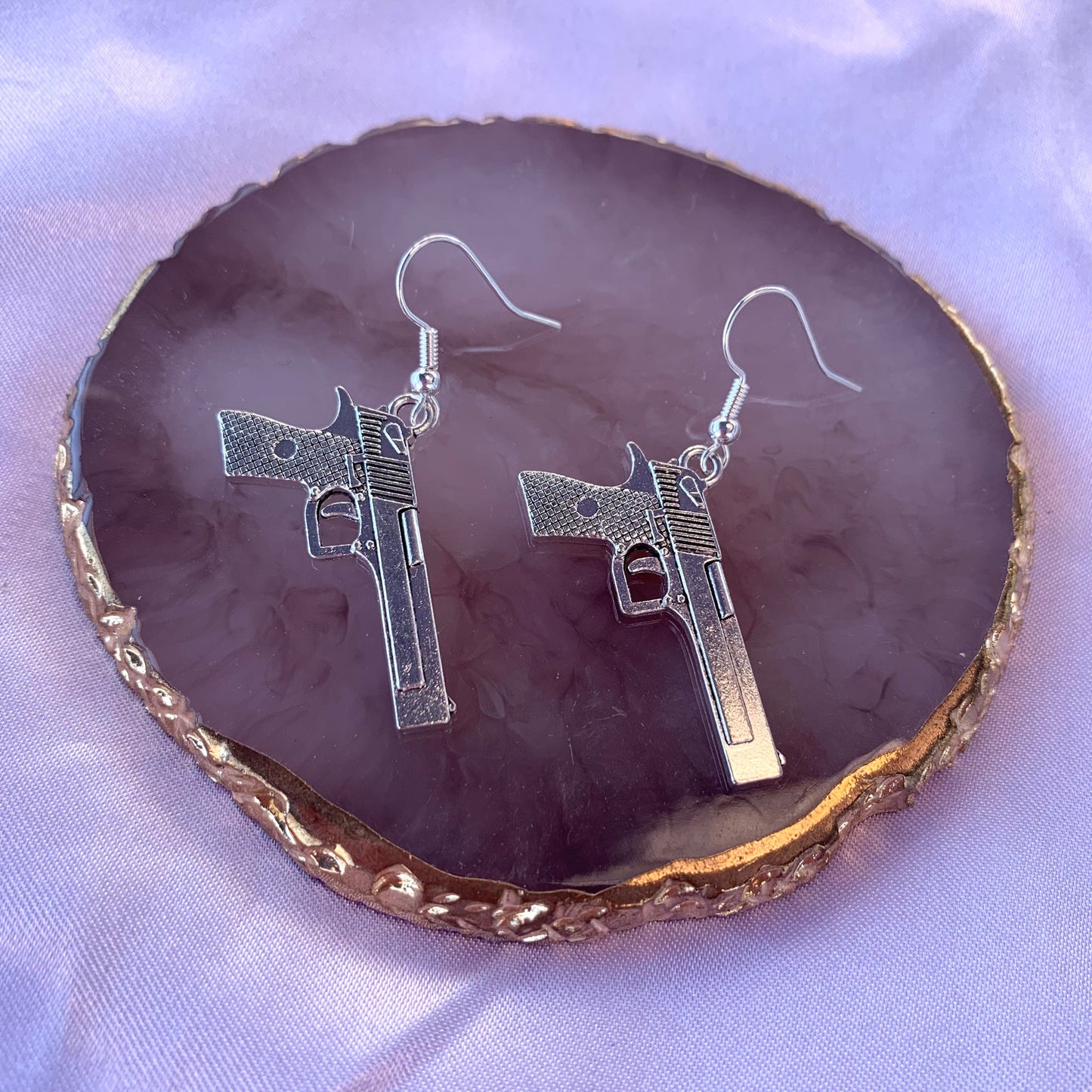 Silver gun dangle earrings