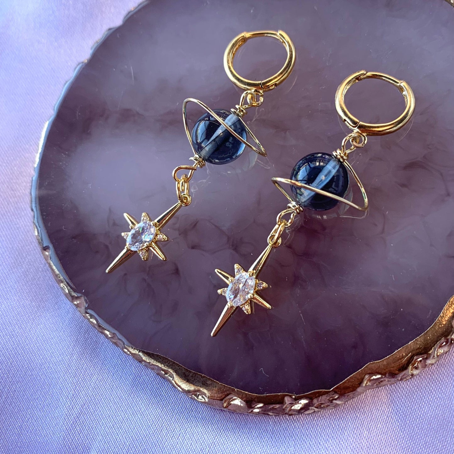 Gold plated celestial Saturn planet dangle hoop earrings with diamanté star