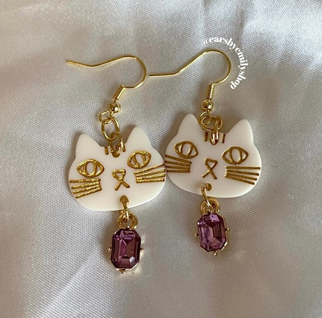 White and gold crystal cat gold dangle earrings