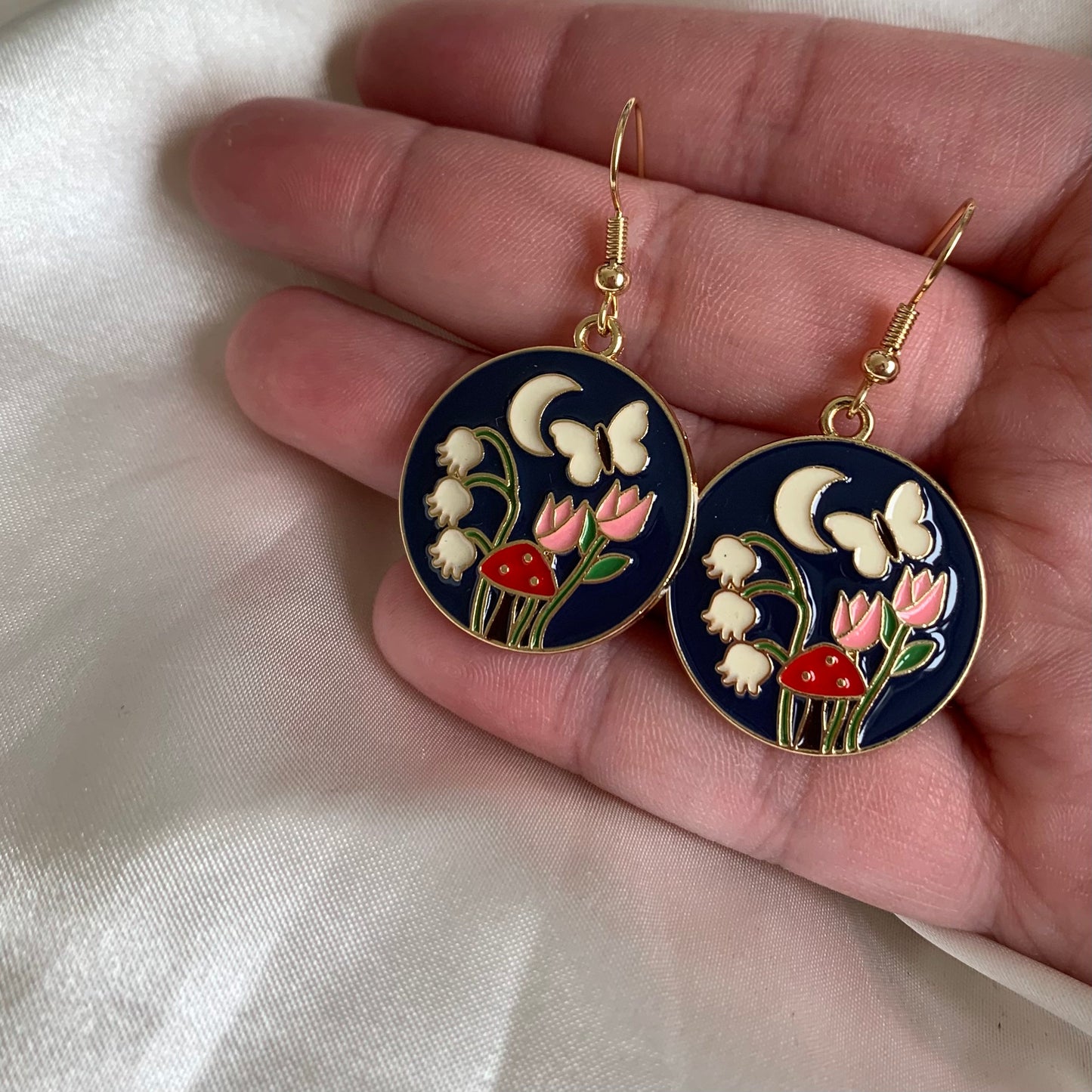 Navy blue circle with flowers and butterfly gold earrings